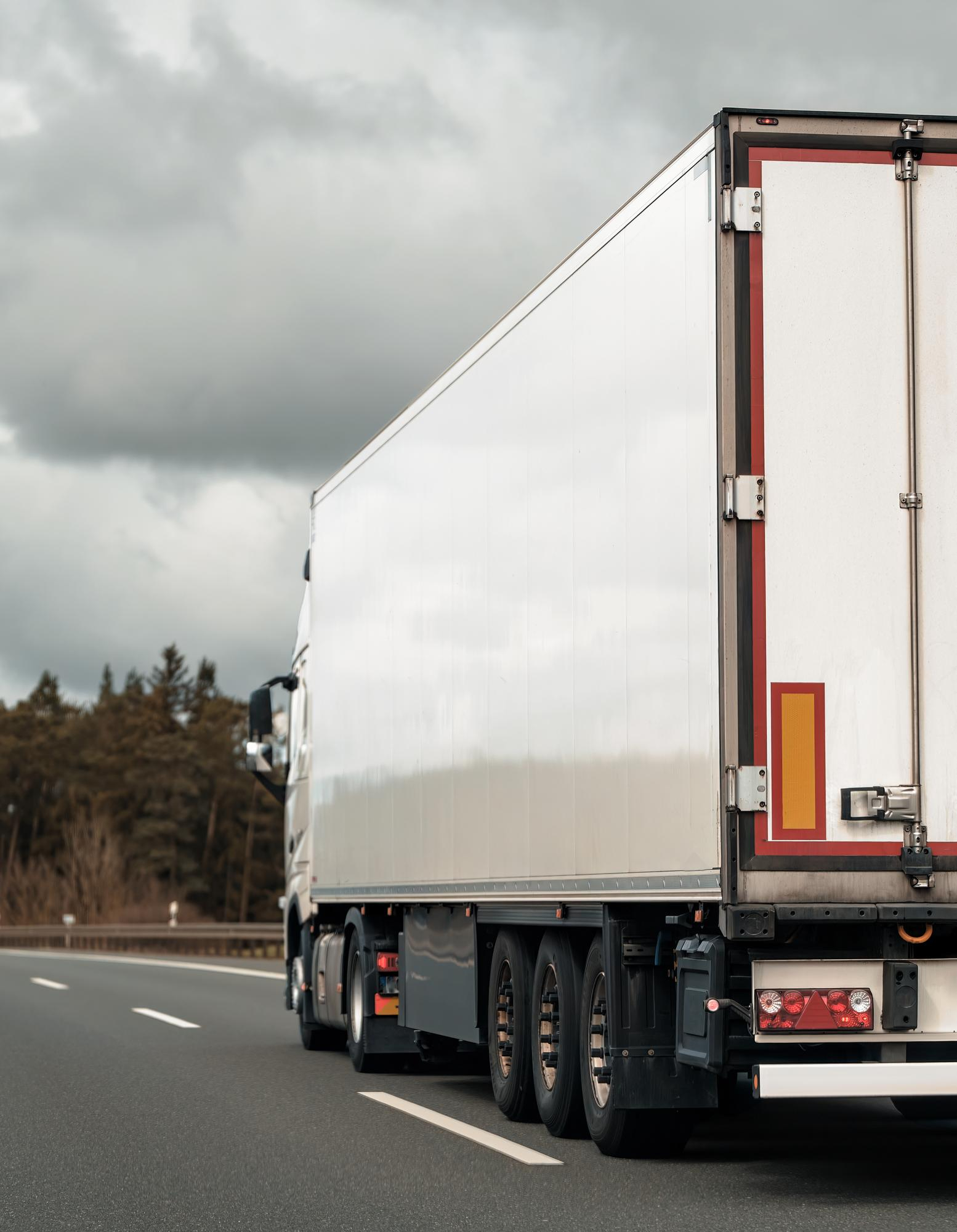 Lorry from behind driving down road